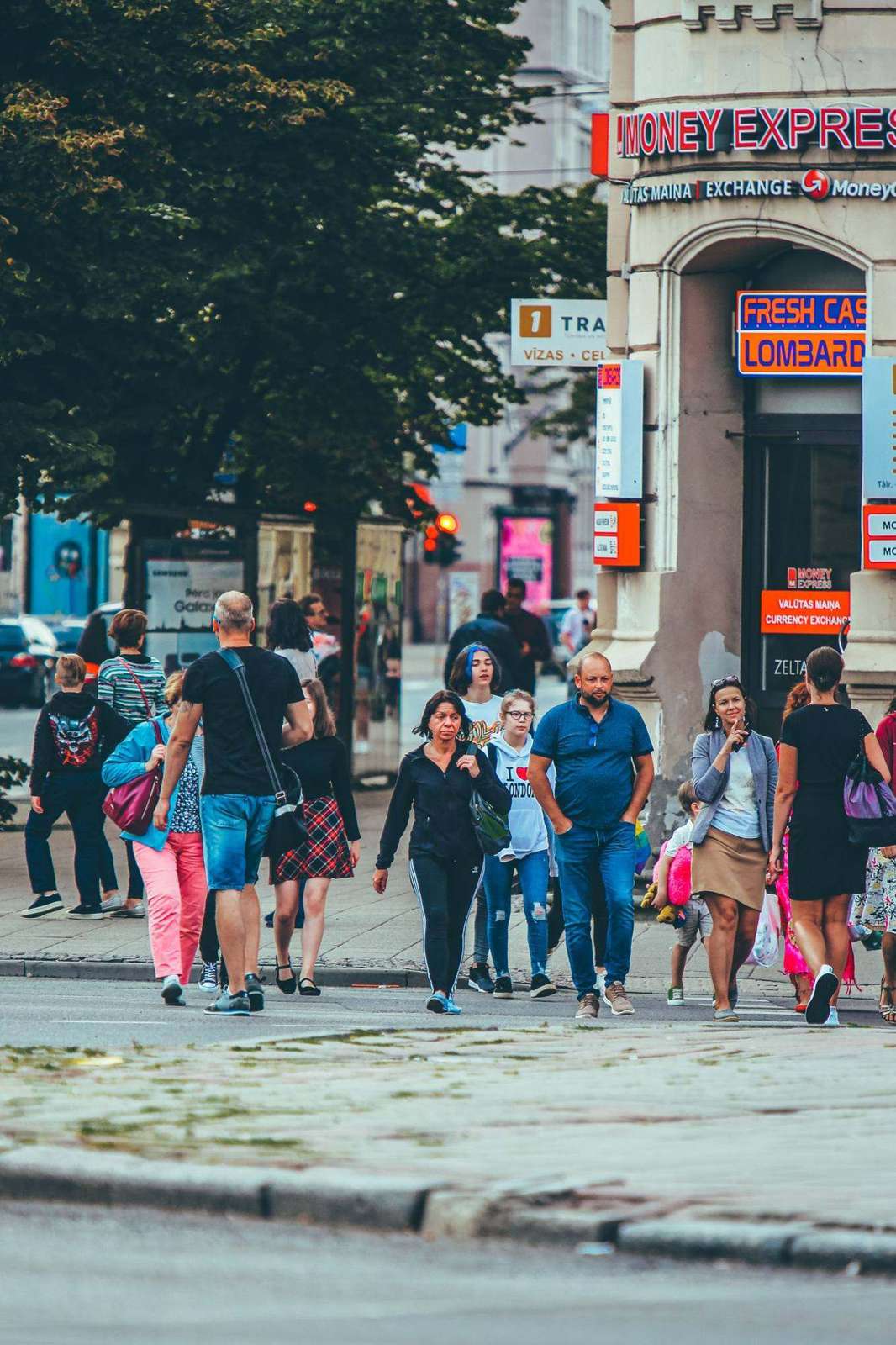 A crowded street of people mid-stride