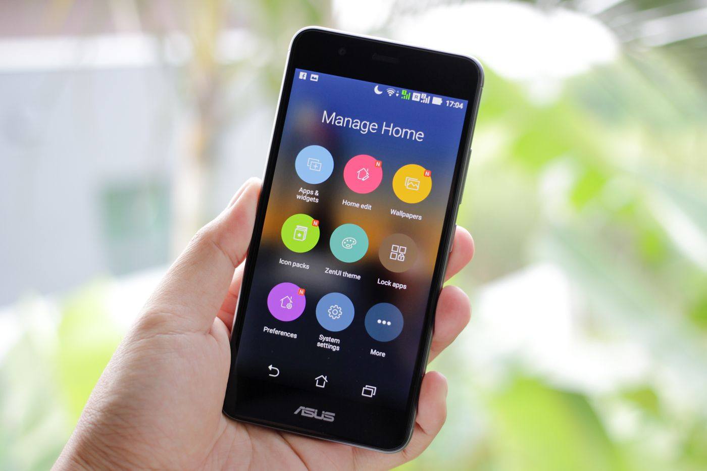 A hand holding a phone on an app-management screen