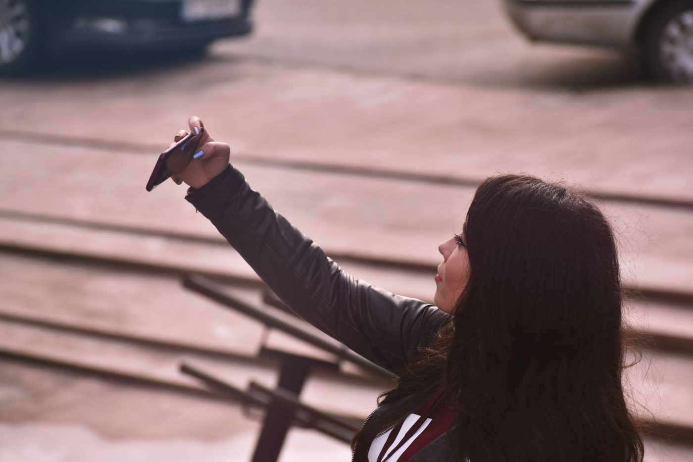 A woman holding up her phone to take a selfie
