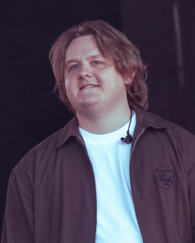 Lewis Capaldi smiling on stage at Glastonbury in 2025
